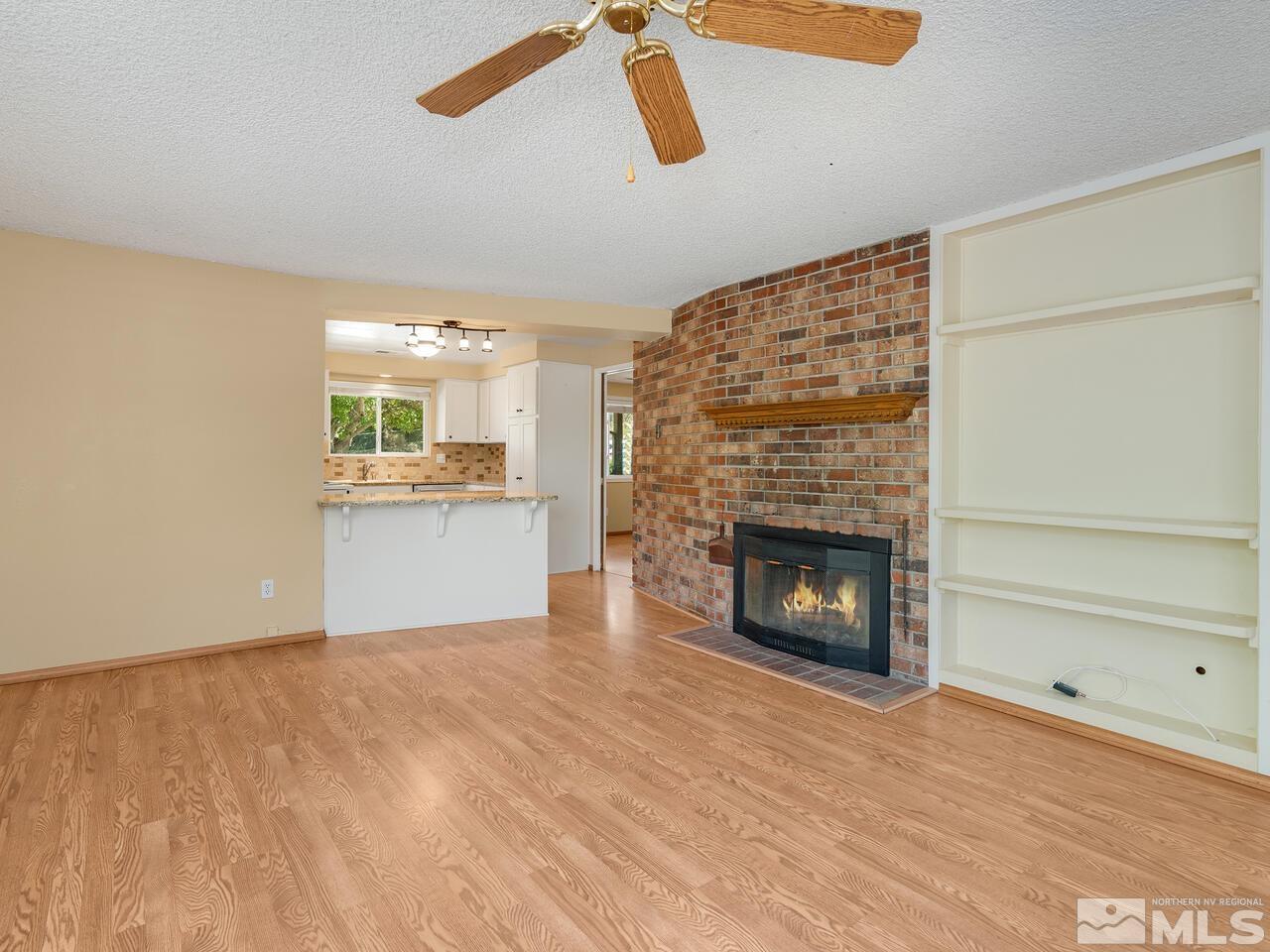 14015 Minnetonka Circle Reno, NV 89521 - Photo 11 of 22 a view of a room wooden floor fire place and windows