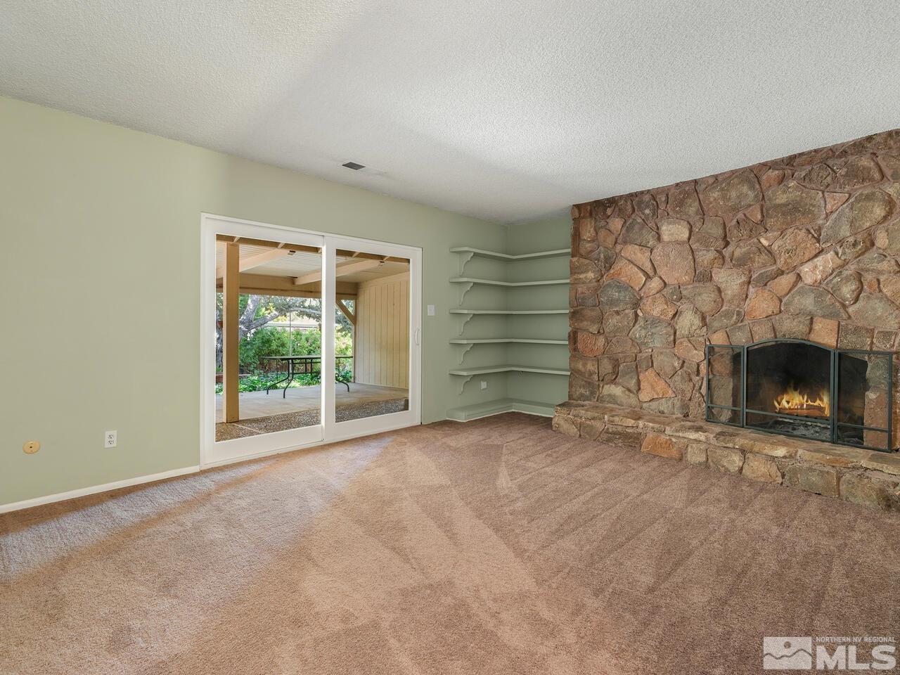 14015 Minnetonka Circle Reno, NV 89521 - Photo 3 of 22 a view of an empty room with a fireplace and a window