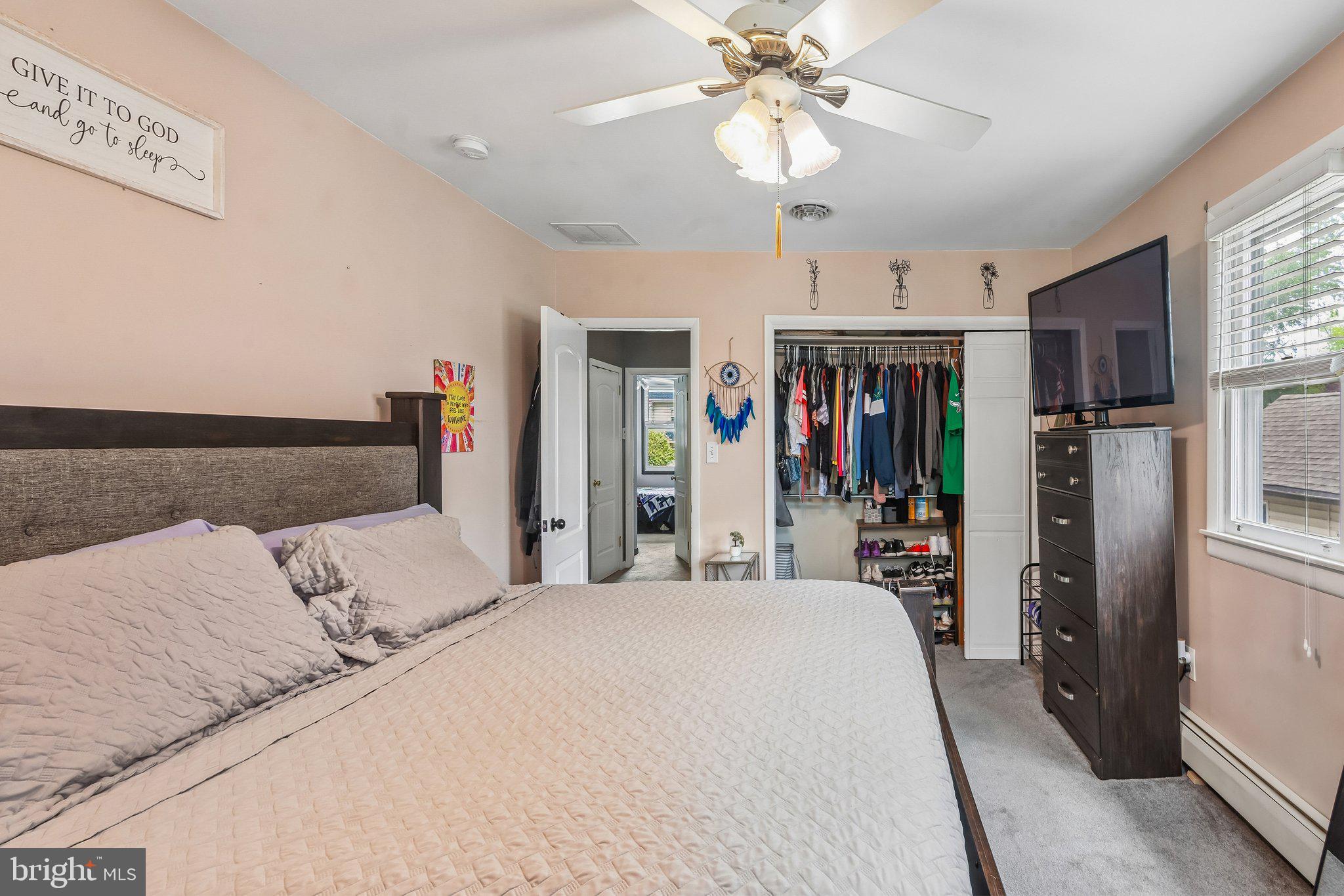 878 Crescent Avenue Runnemede, NJ 08078 - Photo 11 of 24 a bedroom with a large bed and a chandelier