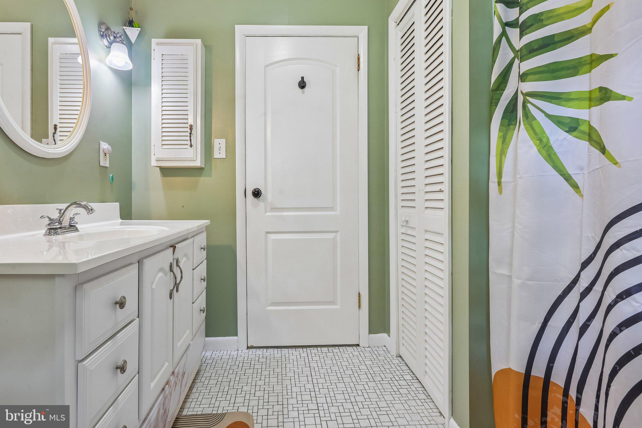 878 Crescent Avenue Runnemede, NJ 08078 - Photo 18 of 24 a bathroom with a sink a mirror and a shower