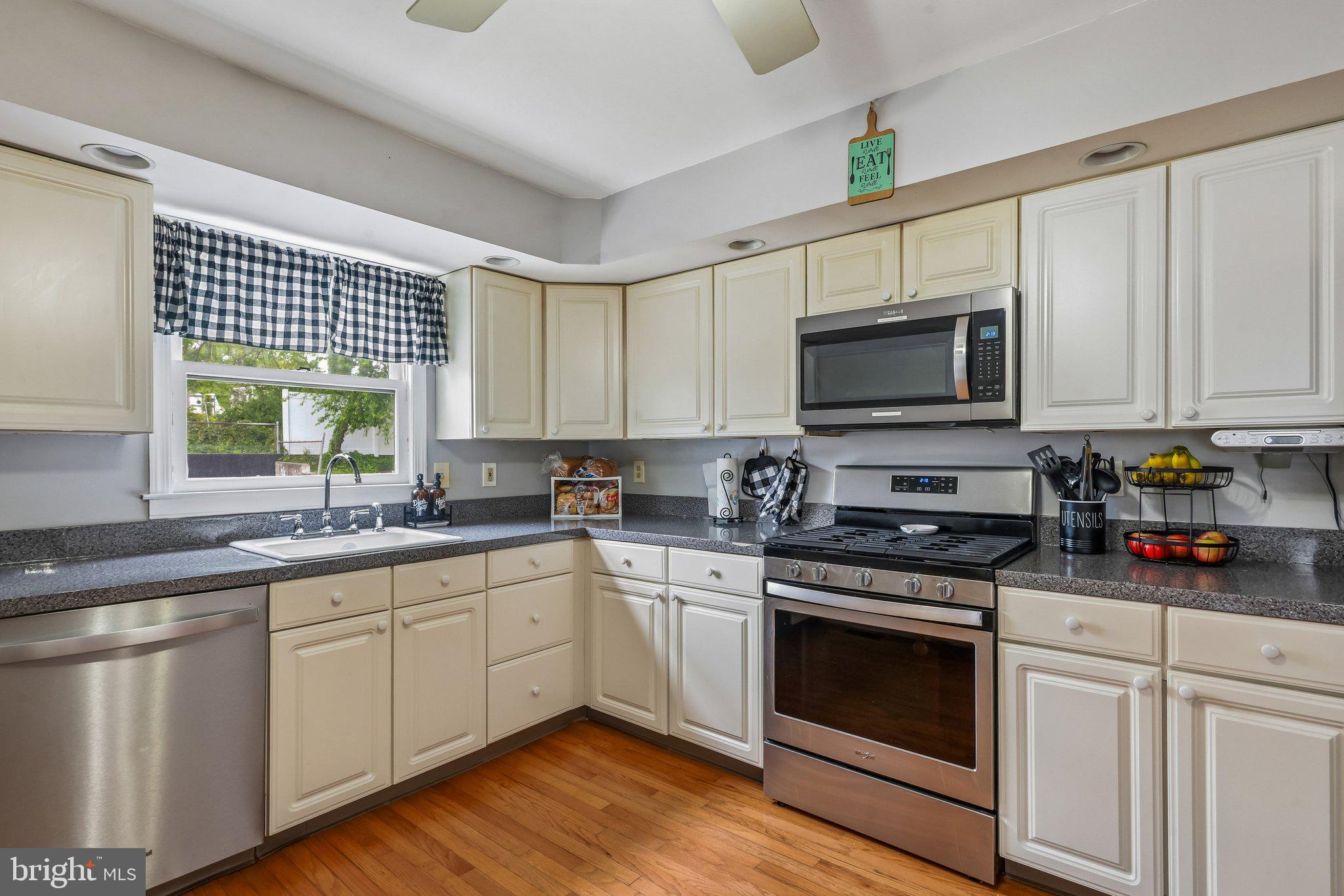878 Crescent Avenue Runnemede, NJ 08078 - Photo 5 of 24 a kitchen with stainless steel appliances white cabinets a sink and a stove