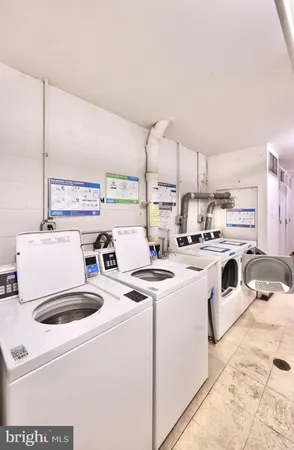 a kitchen with a sink a stove a refrigerator and white cabinets