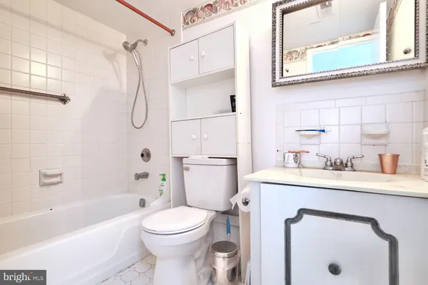 a bathroom with a sink toilet vanity and shower