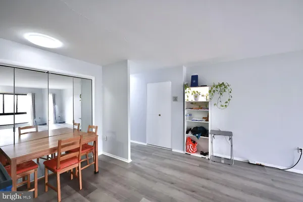 a room with furniture a chandelier and wooden floor
