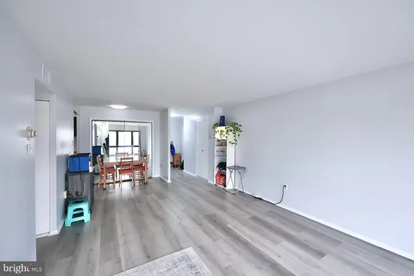 an empty room with furniture and wooden floor