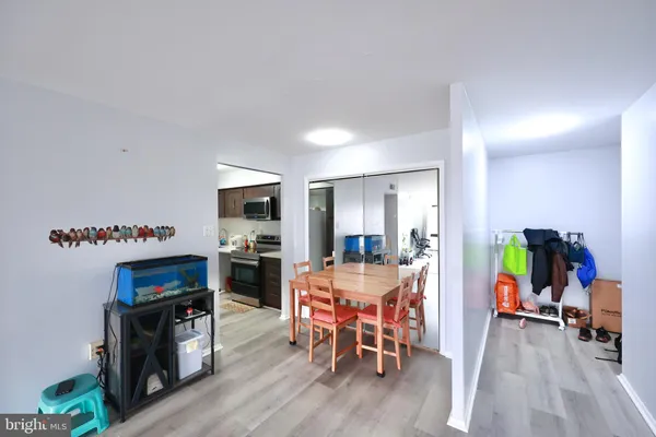a dining room with furniture and wooden floor