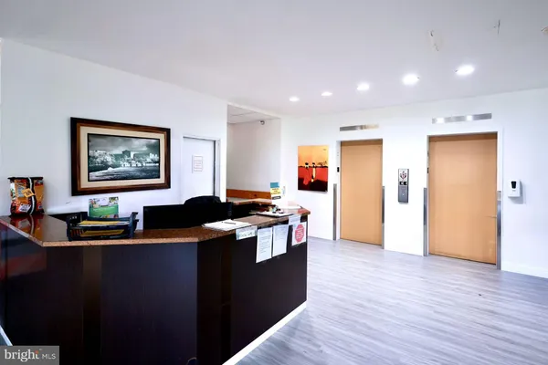 a kitchen with stainless steel appliances granite countertop a sink and a wooden floor