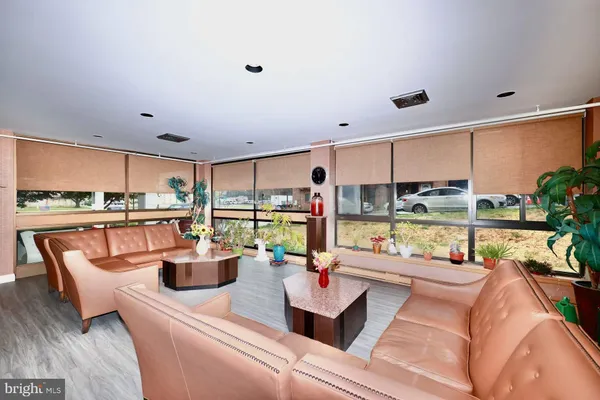a living room with lots of furniture and view of kitchen