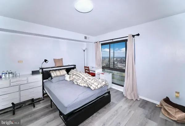 a bedroom with a bed and window