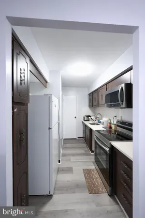 a kitchen with stainless steel appliances granite countertop a stove a refrigerator and a microwave