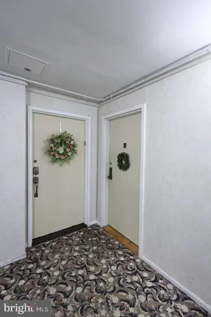 a view of a hallway with wooden floor and a closet