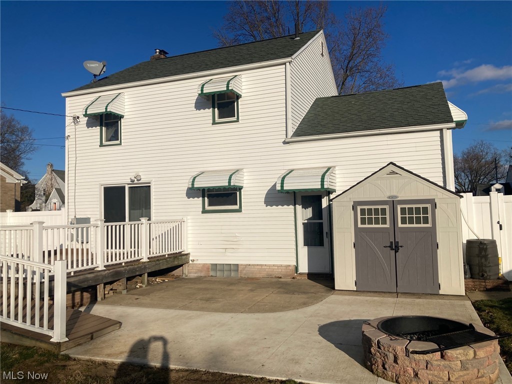 233 Raff Road Northwest Canton, OH 44708 - Photo 19 of 24 Rear view of property with a storage unit, an outdoor fire pit, a patio area, and deck
