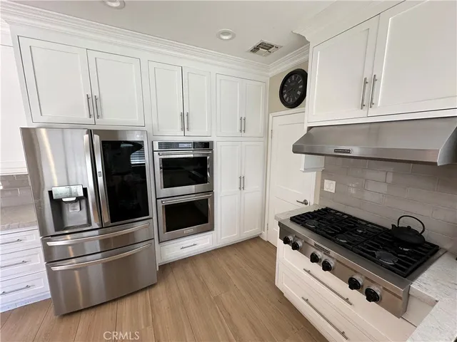 a kitchen with stainless steel appliances granite countertop a stove and a microwave
