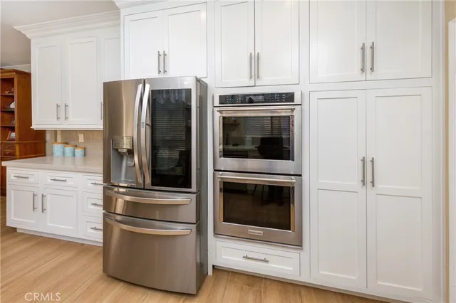 a kitchen with stainless steel appliances and cabinets