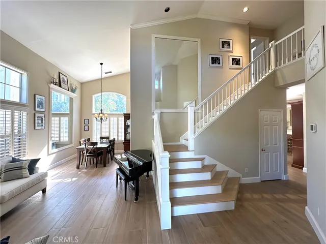 a view of entryway and dining room and wooden floor