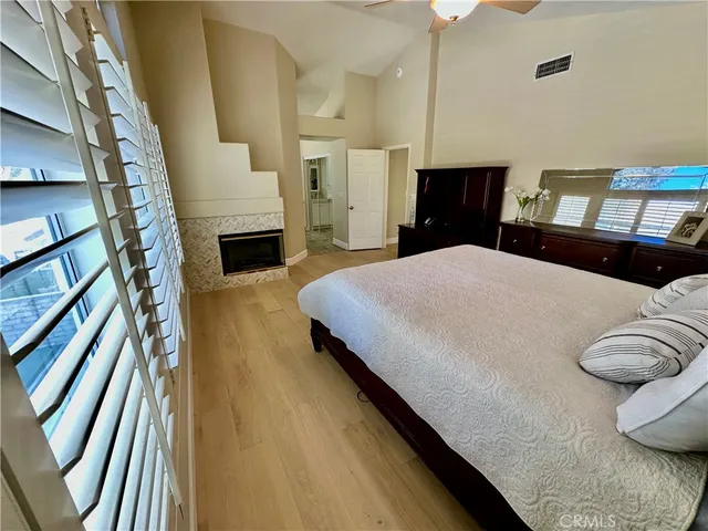 a bedroom with a bed and a fireplace