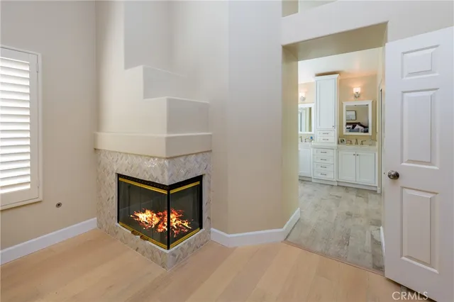 an empty room with fireplace and windows