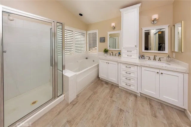 a bathroom with a tub sink and mirror