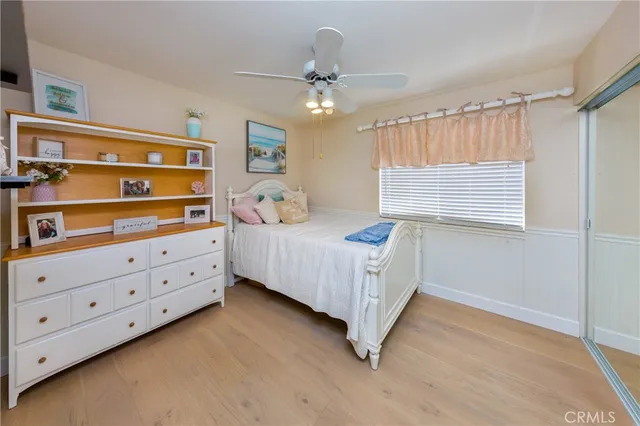 a bedroom with a bed dresser and a window