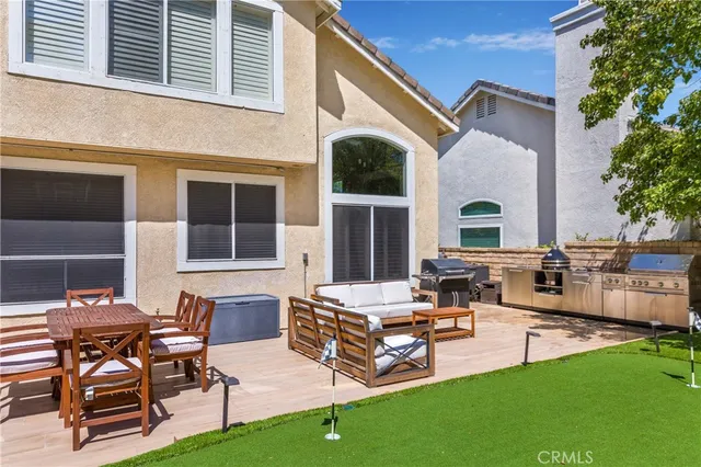 a view of a house with patio and a yard