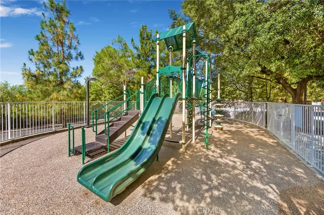 a view of a park with iron fence