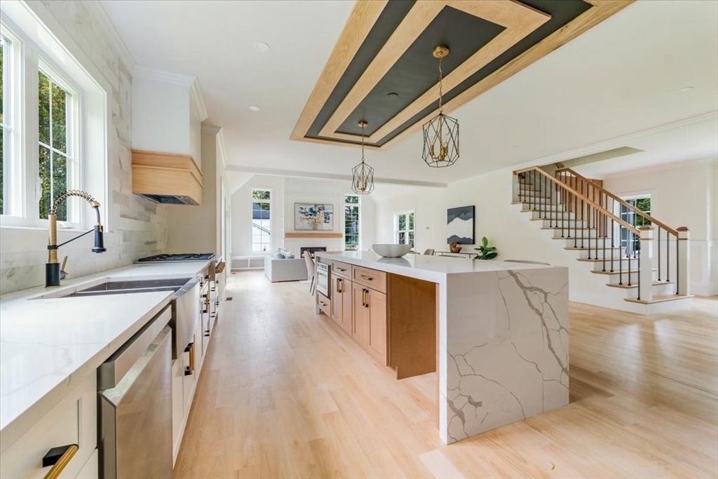 103 Center Street Hanover, MA 02339 - Photo 11 of 42 a kitchen with stainless steel appliances granite countertop a lot of counter space and wooden floors