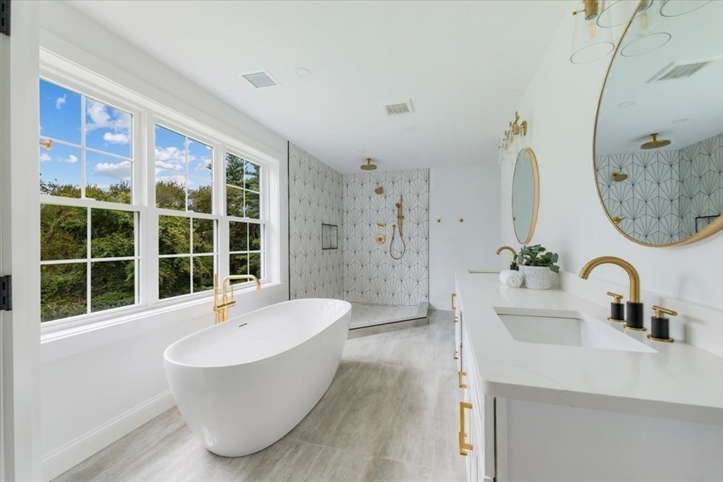 103 Center Street Hanover, MA 02339 - Photo 23 of 42 a bathroom with a tub sink and mirror