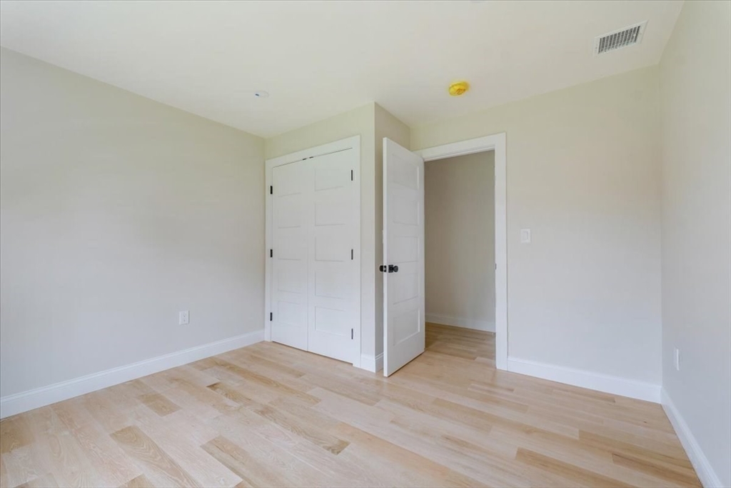 103 Center Street Hanover, MA 02339 - Photo 32 of 42 an empty room with wooden floor