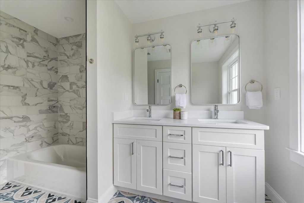 103 Center Street Hanover, MA 02339 - Photo 35 of 42 a bathroom with a granite countertop sink mirror and a bathtub