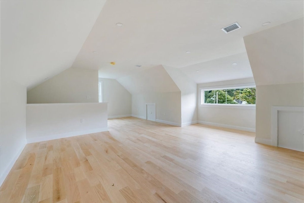 103 Center Street Hanover, MA 02339 - Photo 37 of 42 an empty room with wooden floor and windows