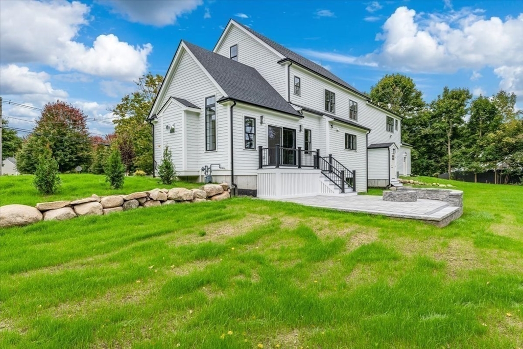 103 Center Street Hanover, MA 02339 - Photo 5 of 42 a front view of house with a garden and patio