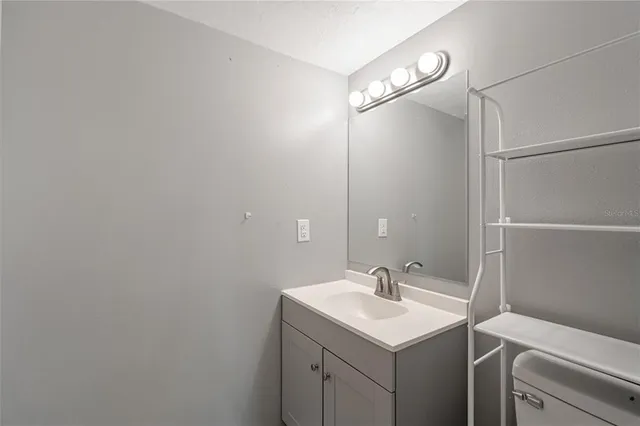 a bathroom with a sink vanity and a mirror