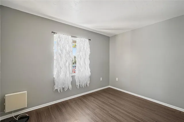 a view of room with hardwood floor and window
