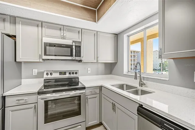 a kitchen with a sink stove and microwave