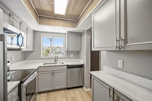 a kitchen with a sink cabinets and appliances