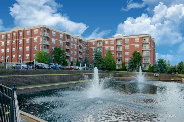 a view of building with lake view and trees in the background
