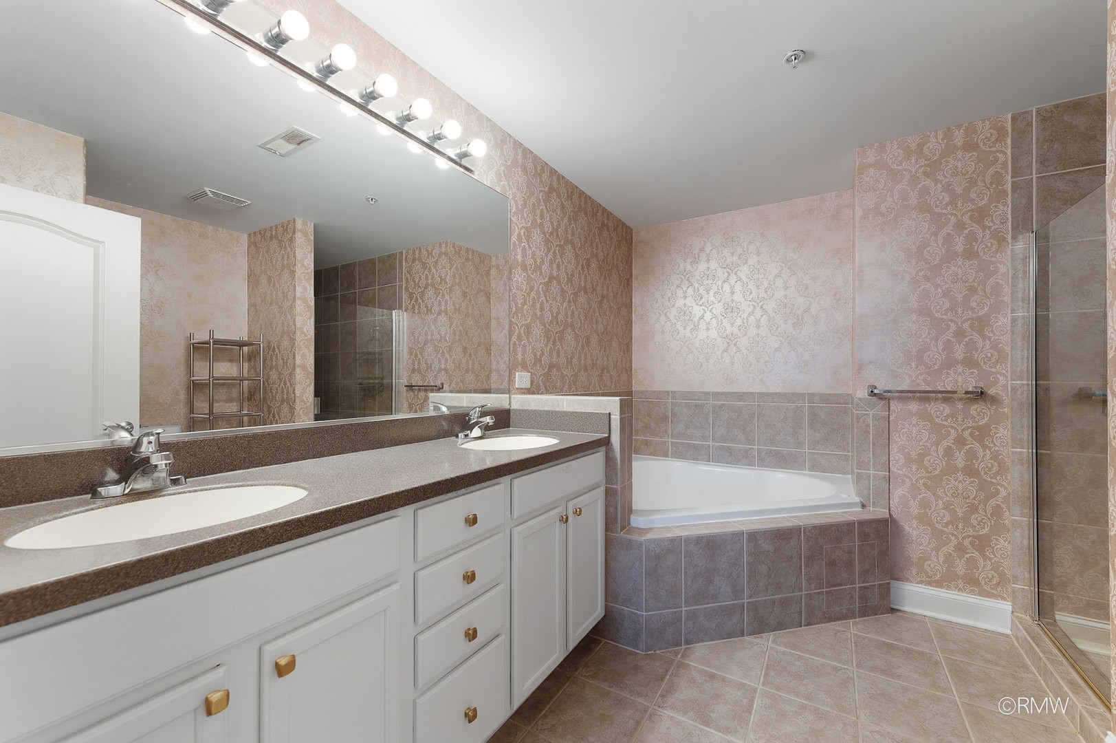 1 Itasca Place, Unit 412 Addison, IL 60143 - Photo 23 of 28 a bathroom with a sink double vanity granite tub and a mirror