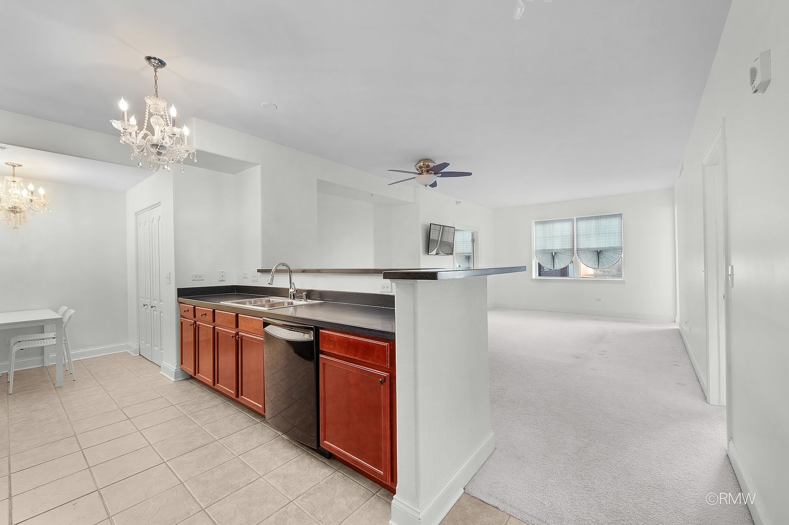 1 Itasca Place, Unit 412 Addison, IL 60143 - Photo 10 of 28 a large white kitchen with cabinets a sink and dishwasher