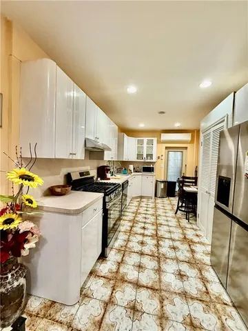 a kitchen with stainless steel appliances a stove a sink and a refrigerator