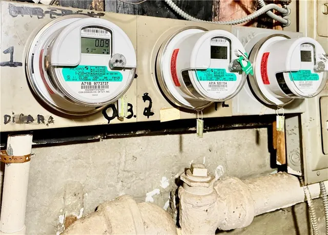 a view of a buildings with cars parked on the road