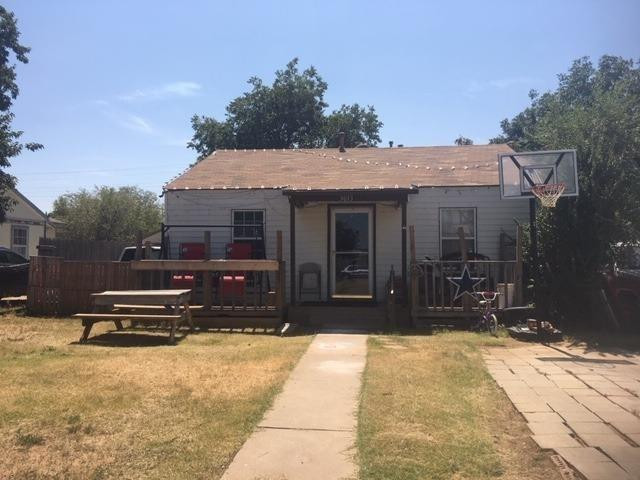 a view of a house with a yard and sitting area