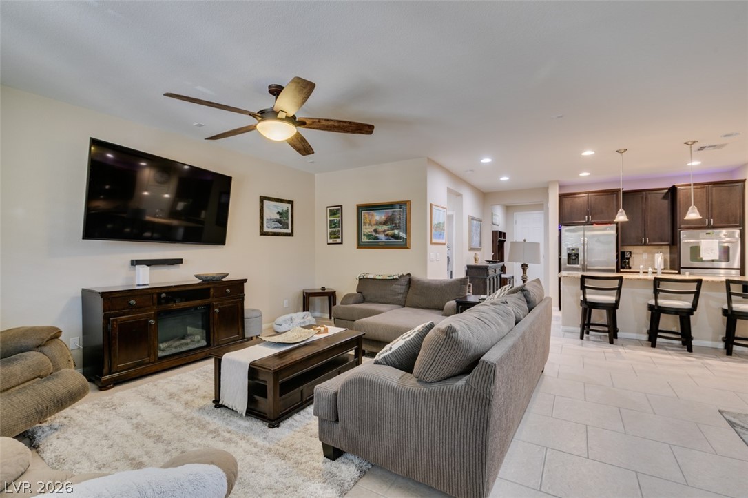 7375 Campbell Ranch Avenue Las Vegas, NV 89179 - Photo 21 of 45 An inviting open-concept living area boasts recessed lighting and a ceiling fan, offering a seamless flow to the kitchen.