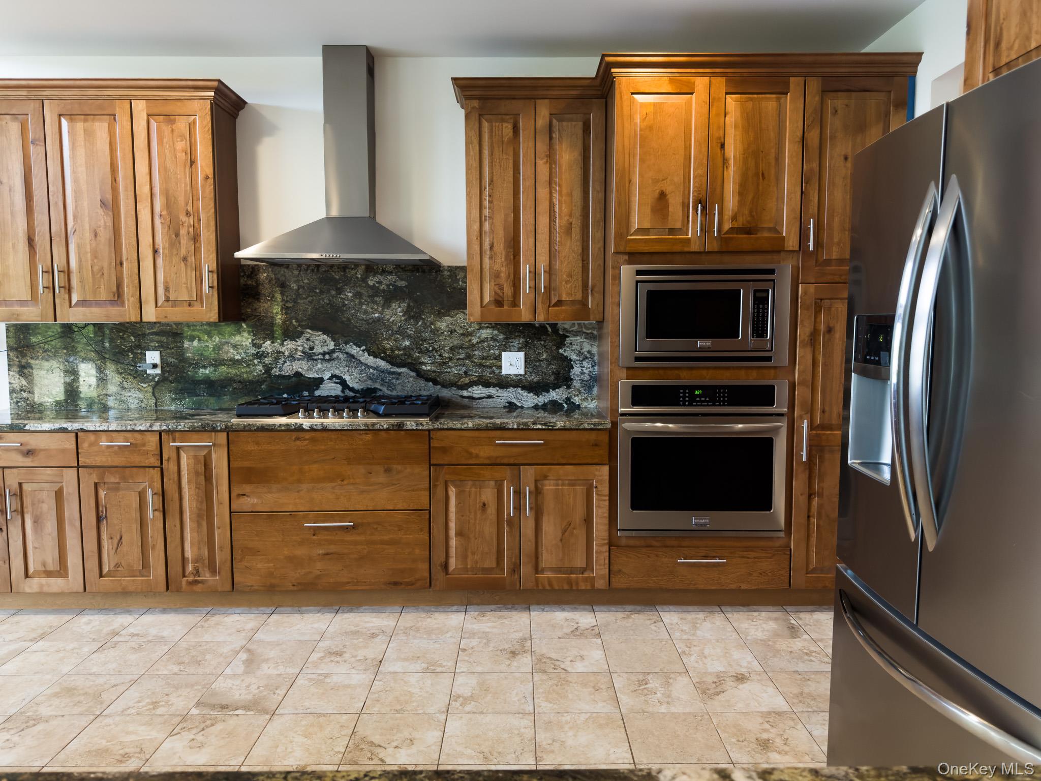 58 Deer Meadow Road White Lake, NY 12786 - Photo 13 of 41 Kitchen featuring stainless steel appliances, brown cabinets, and wall chimney range hood