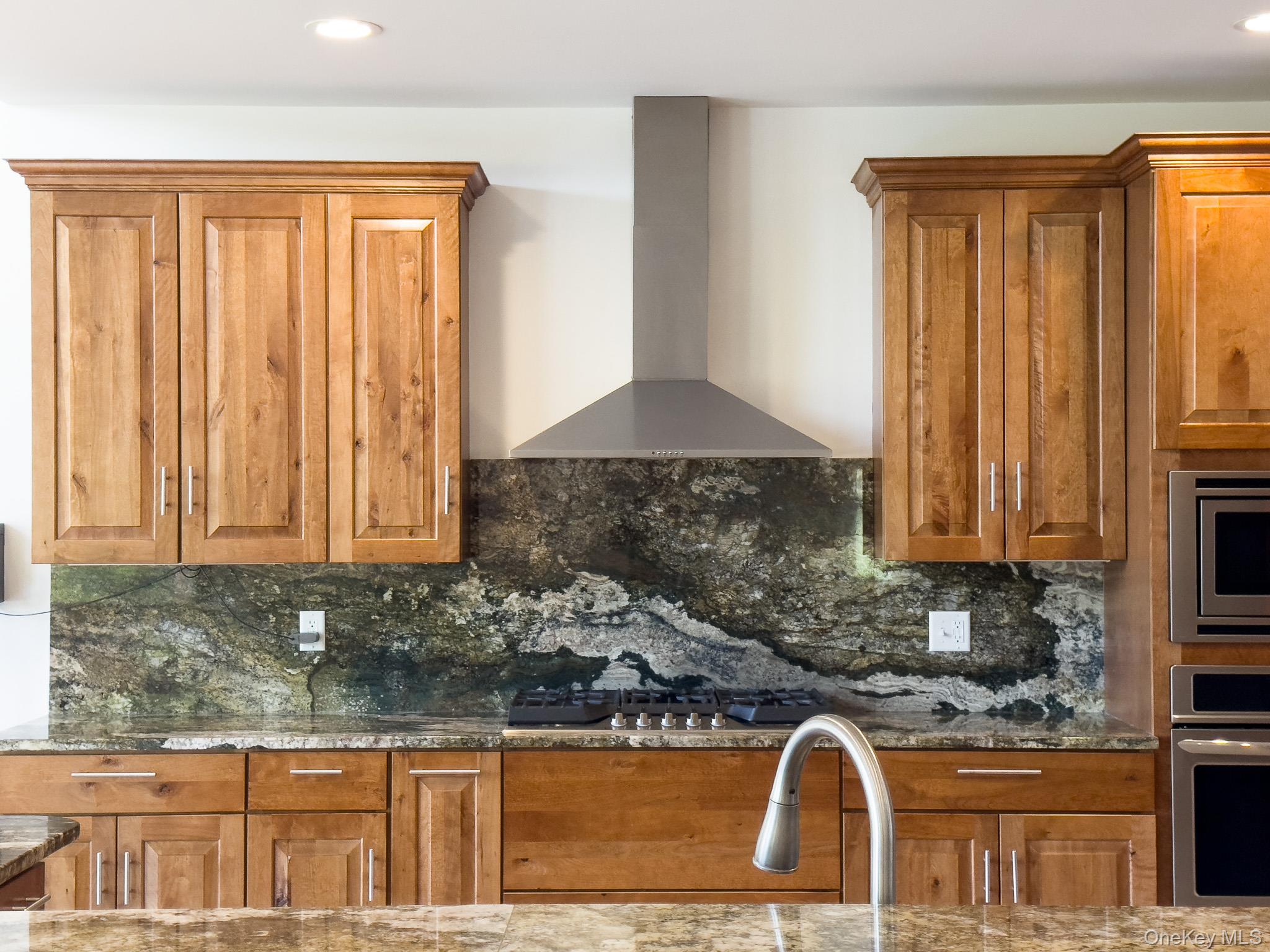 58 Deer Meadow Road White Lake, NY 12786 - Photo 14 of 41 Kitchen featuring brown cabinetry, decorative backsplash, dark stone countertops, appliances with stainless steel finishes, and recessed lighting