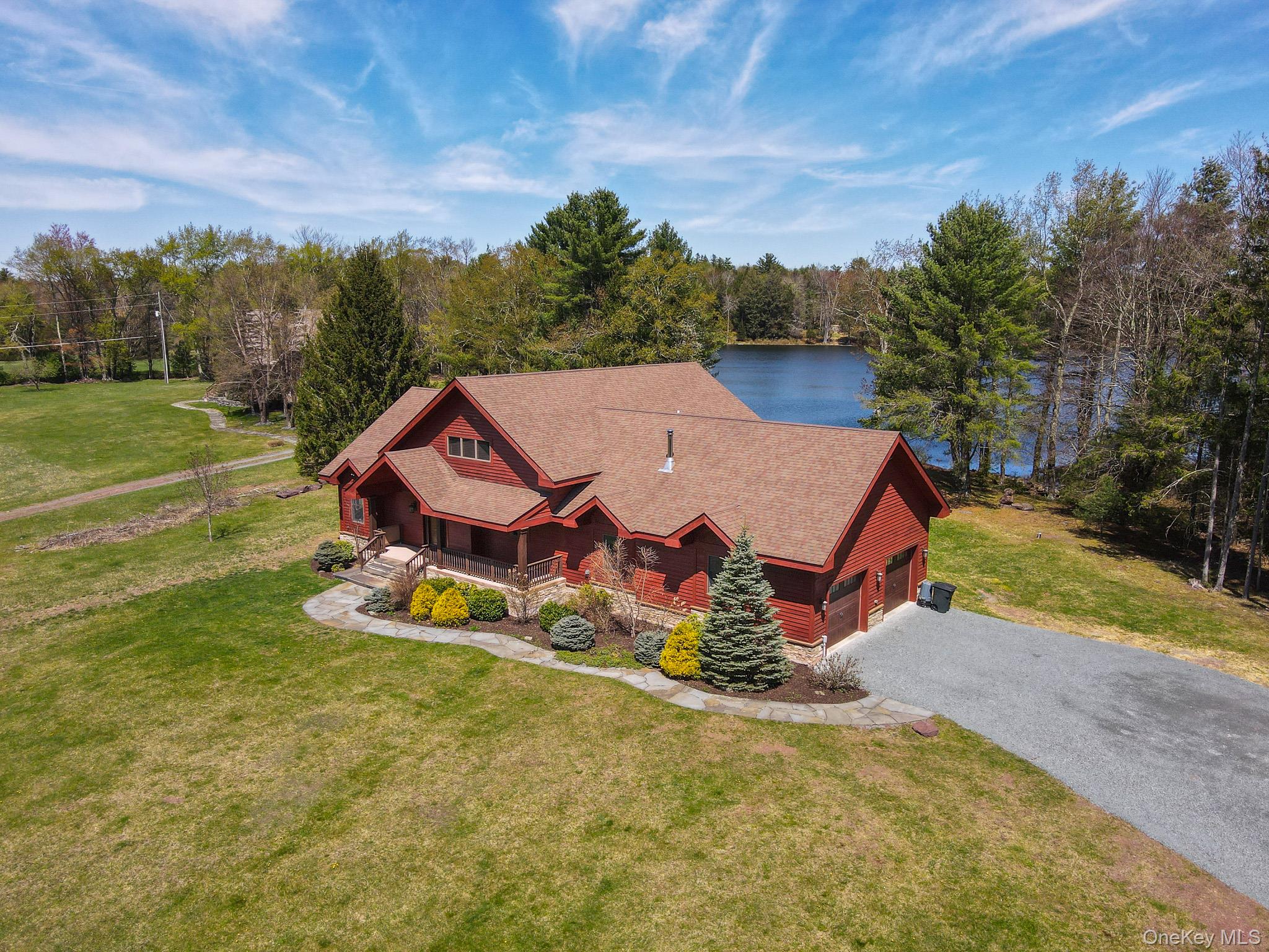 58 Deer Meadow Road White Lake, NY 12786 - Photo 3 of 41 View of front of home with a front yard, covered porch, asphalt driveway, and a garage