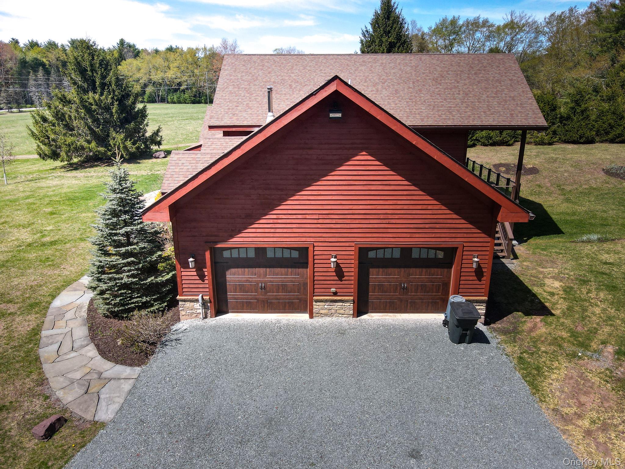 58 Deer Meadow Road White Lake, NY 12786 - Photo 4 of 41 View of home's exterior with a yard, driveway, a shingled roof, and stone siding