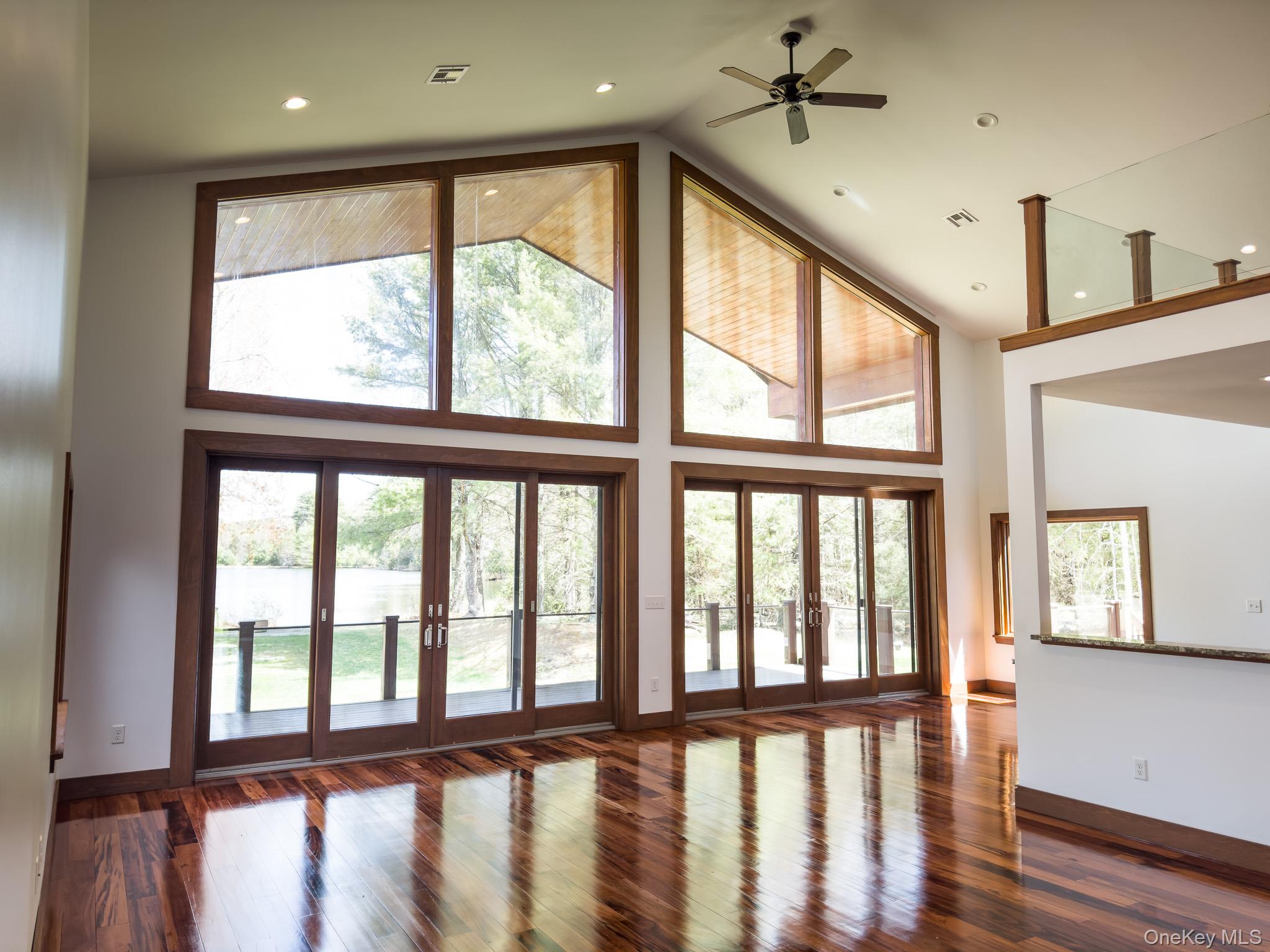 58 Deer Meadow Road White Lake, NY 12786 - Photo 9 of 41 Unfurnished living room with french doors, dark wood finished floors, high vaulted ceiling, ceiling fan, and recessed lighting