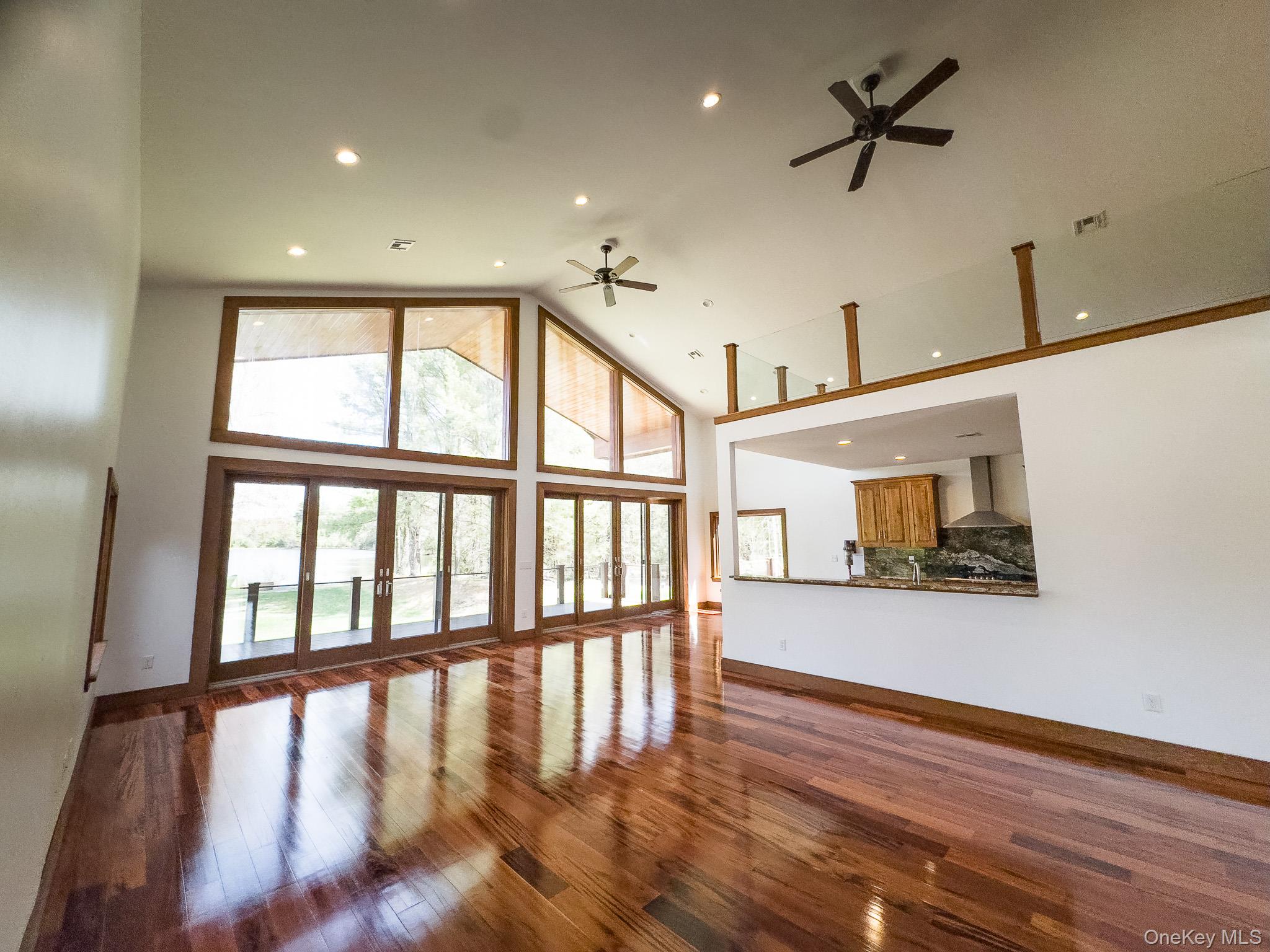 58 Deer Meadow Road White Lake, NY 12786 - Photo 10 of 41 Unfurnished living room with dark wood finished floors, ceiling fan, high vaulted ceiling, and recessed lighting
