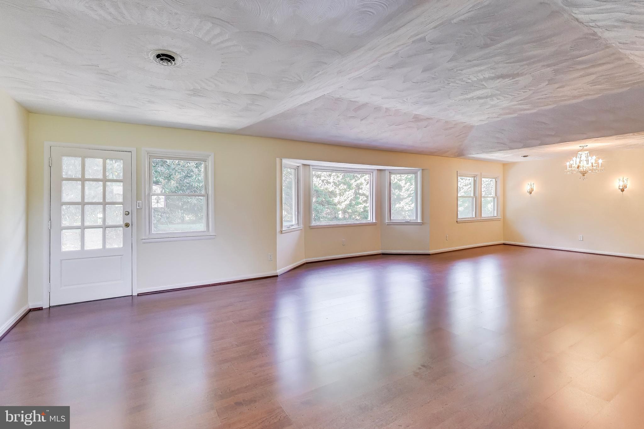 402 Ivy Church Road Lutherville-Timonium, MD 21093 - Photo 27 of 63 a view of an empty room with wooden floor and windows