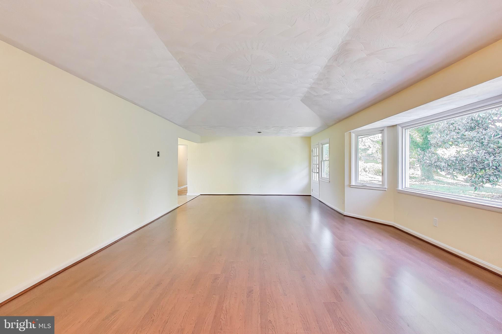 402 Ivy Church Road Lutherville-Timonium, MD 21093 - Photo 29 of 63 a view of an empty room with wooden floor and a window